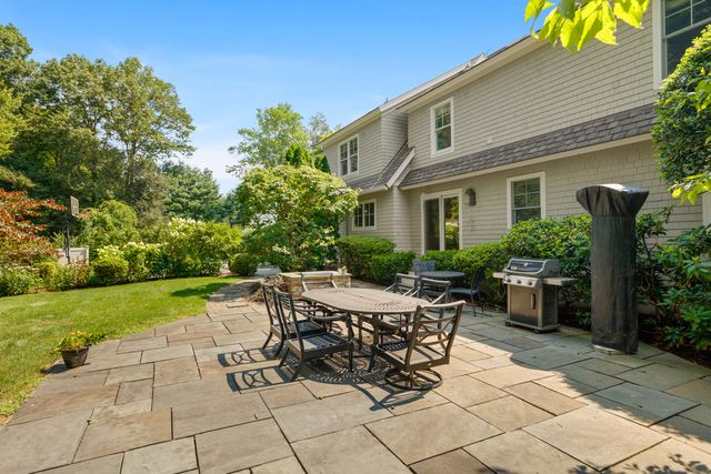 a view of a house with backyard and sitting area