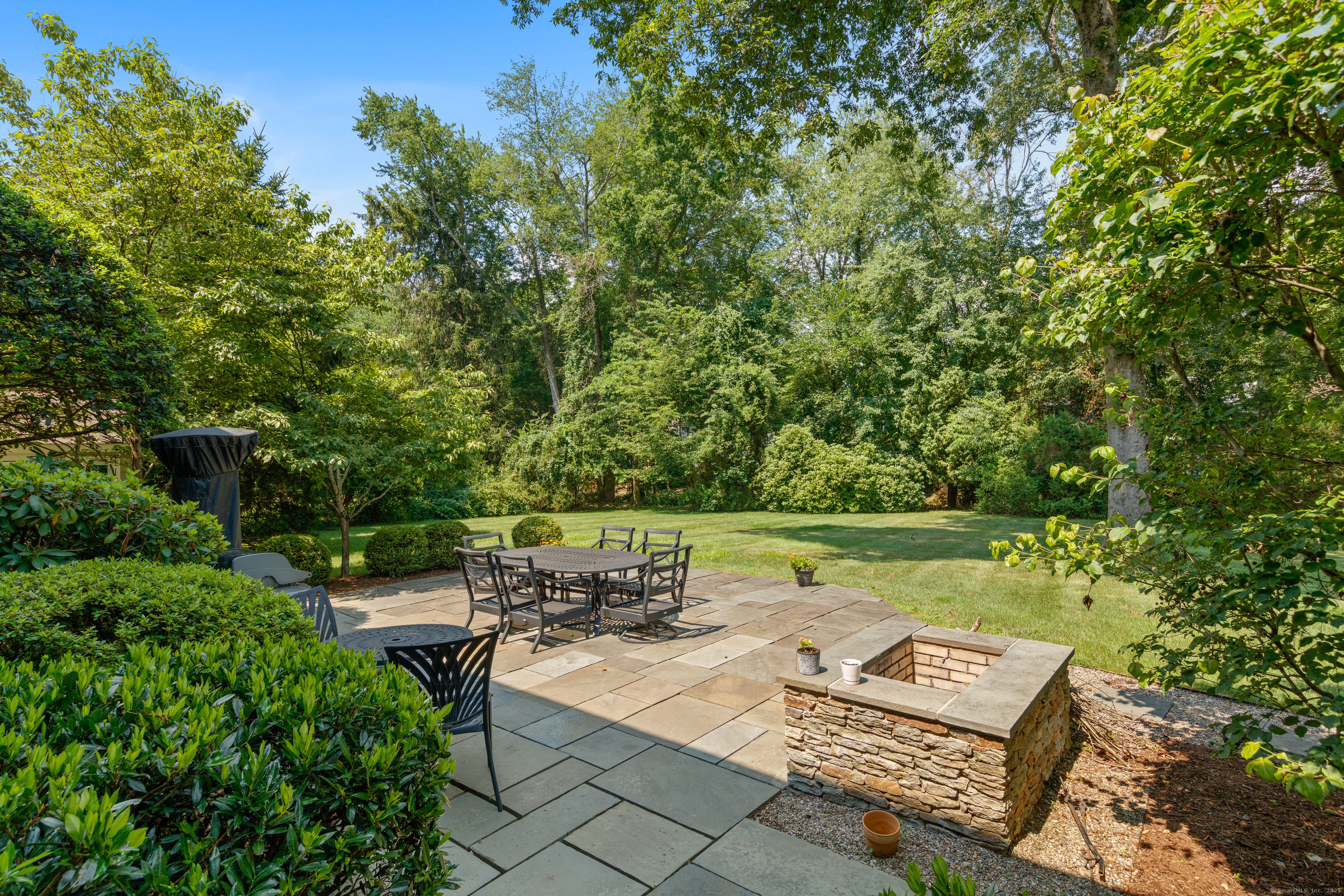 358 Hoyt Street Darien, CT 06820 - Photo 37 of 40 a view of a bench in a garden