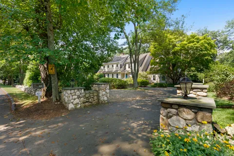 a view of backyard with a table and chairs and potted plants