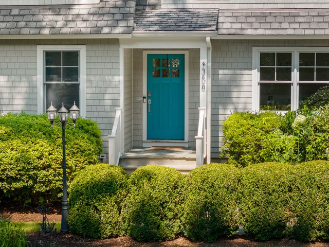 a view of a house with potted plants