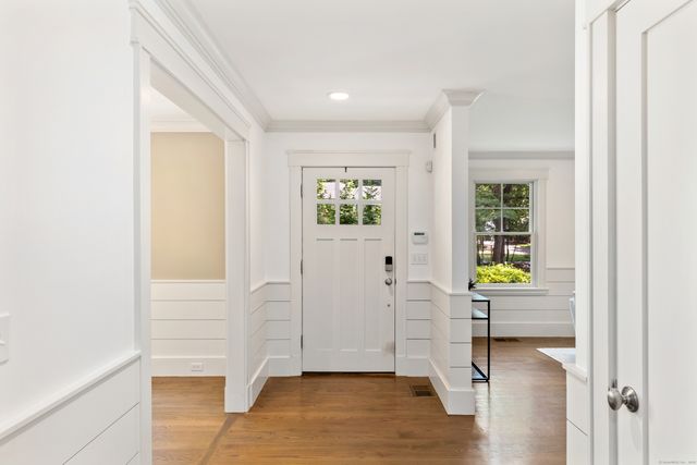 a view of an entryway with wooden floor