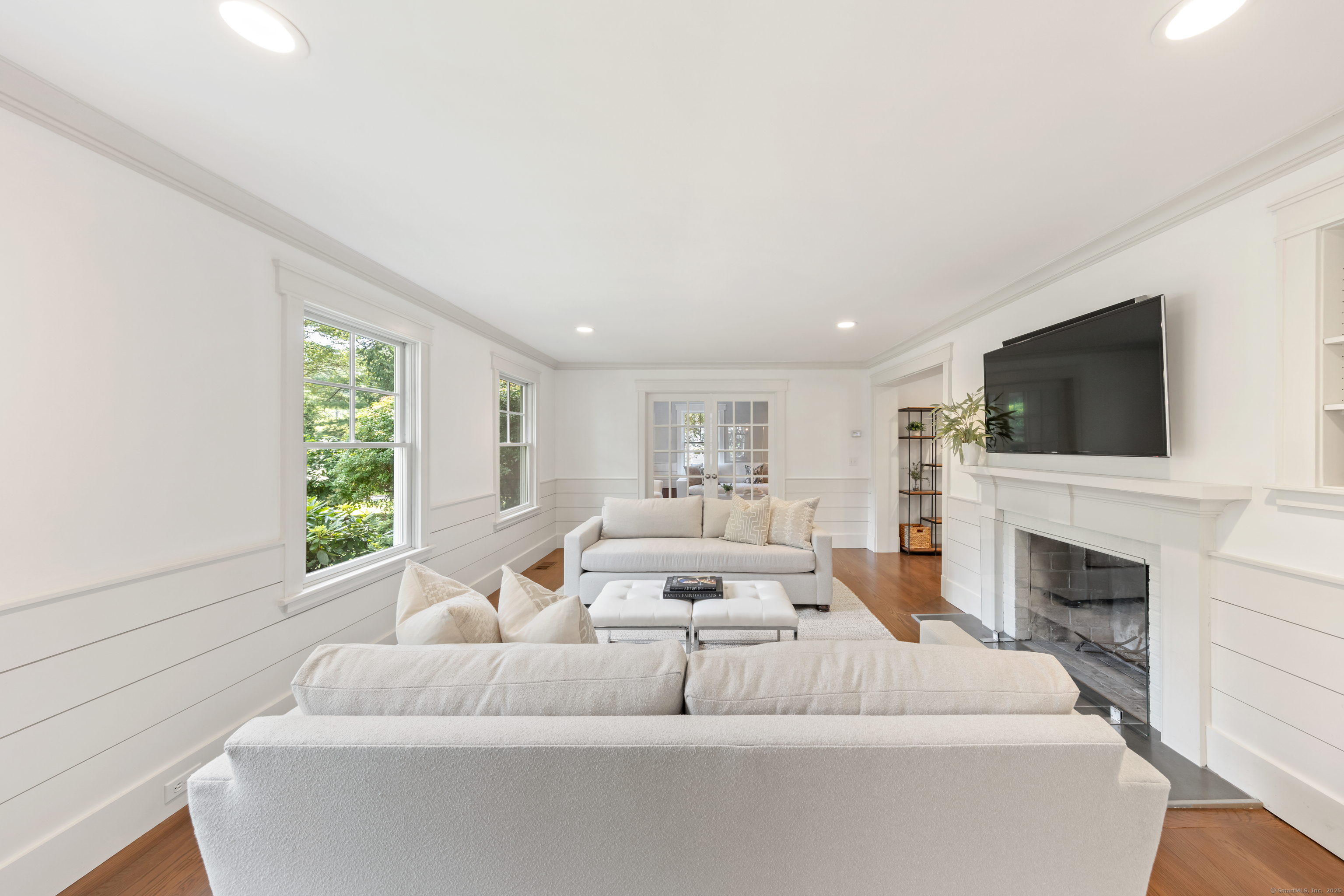 358 Hoyt Street Darien, CT 06820 - Photo 10 of 40 a living room with furniture a fireplace and a flat screen tv