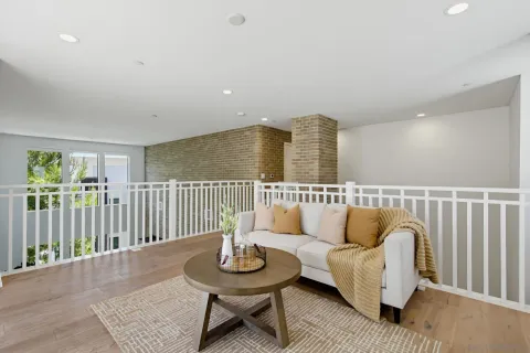 a view of a patio with couches table and chairs and potted plants