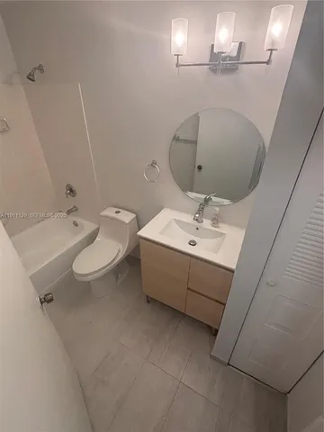 a bathroom with a sink a toilet and mirror