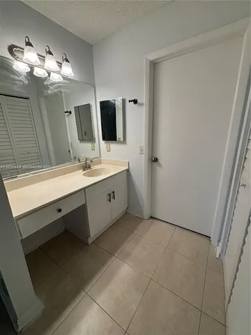 a spacious bathroom with a double vanity sink and mirror