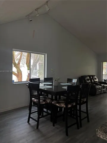 a view of a dining room with furniture and window