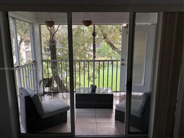 a living room with furniture and a floor to ceiling window