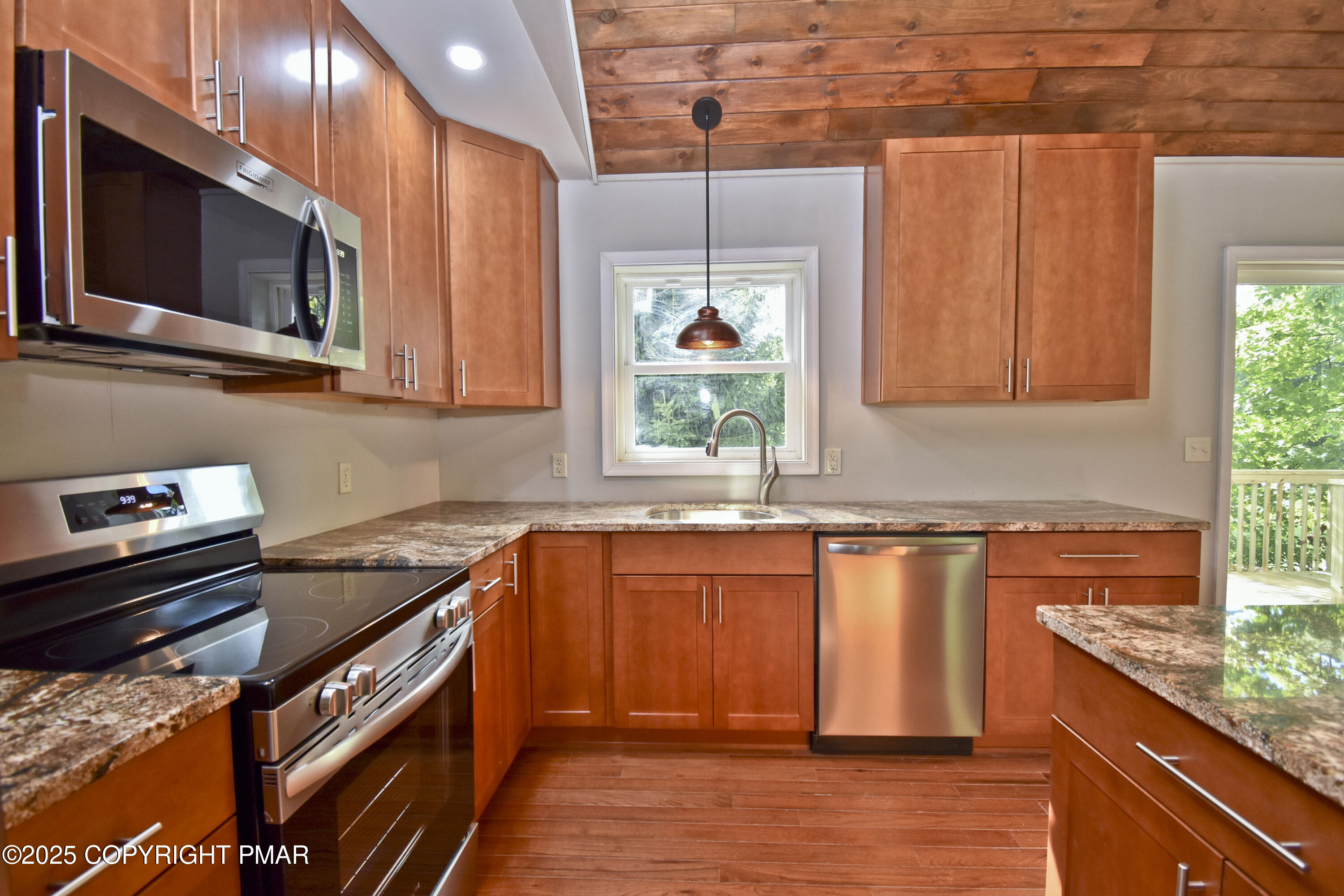 348 Summit Road Swiftwater, PA 18370 - Photo 14 of 47 a kitchen with stainless steel appliances granite countertop a stove a sink and a microwave