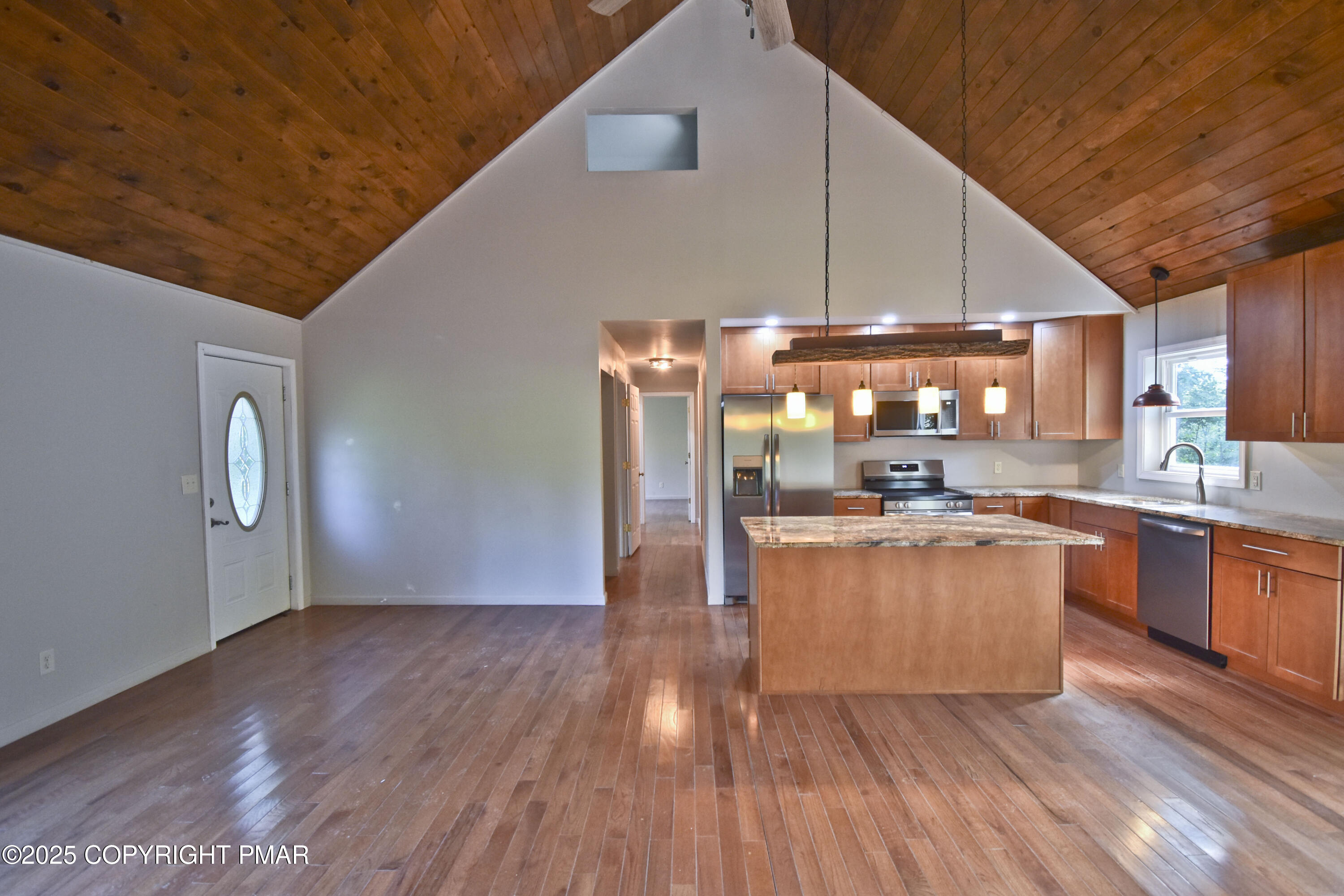 348 Summit Road Swiftwater, PA 18370 - Photo 16 of 47 a kitchen with stainless steel appliances wooden floor and a refrigerator