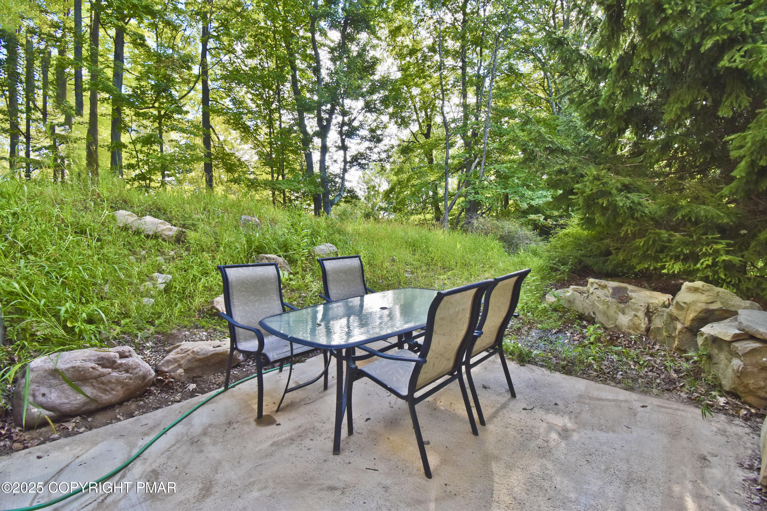 348 Summit Road Swiftwater, PA 18370 - Photo 34 of 47 a view of a chairs and table in the backyard