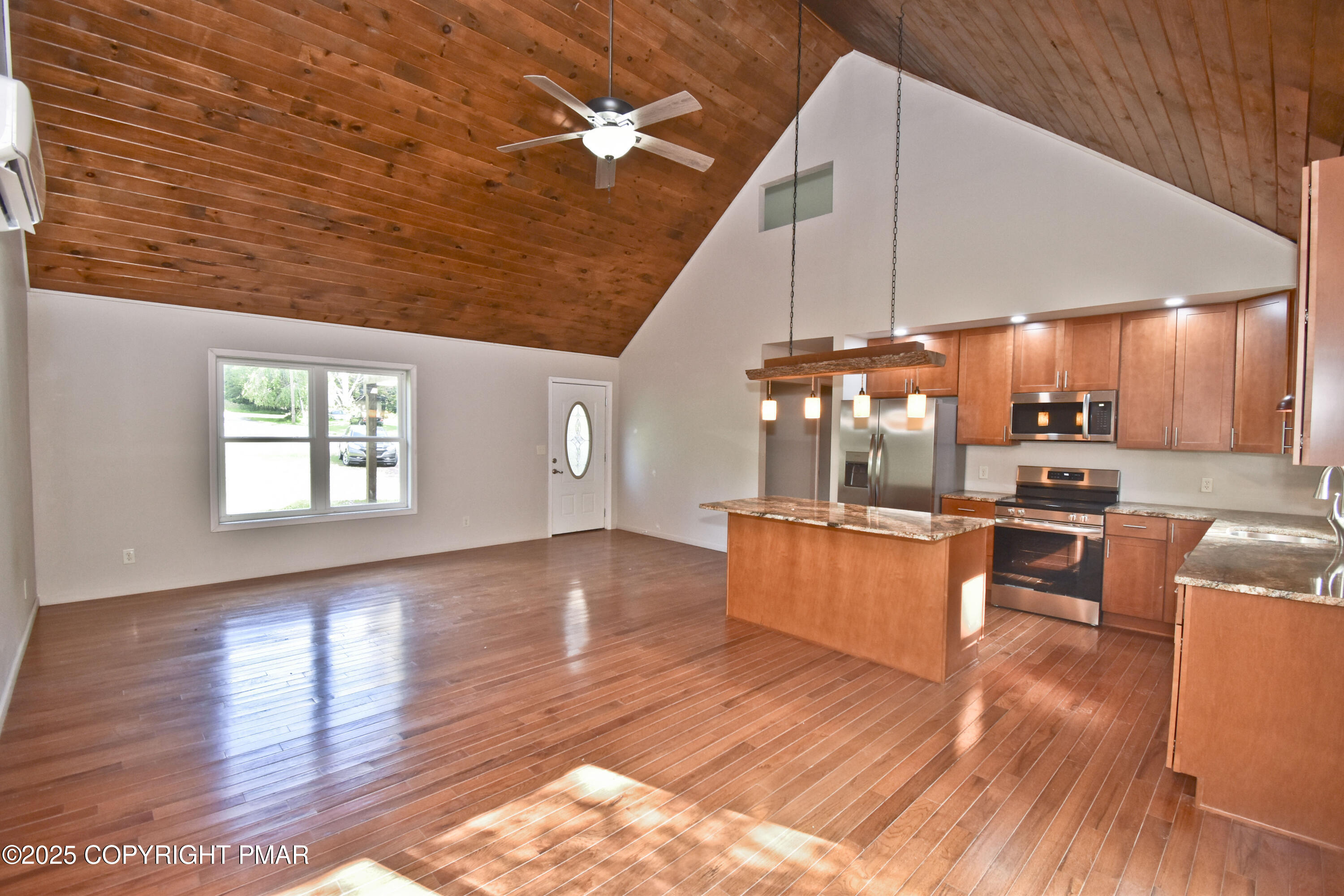348 Summit Road Swiftwater, PA 18370 - Photo 8 of 47 a kitchen with stainless steel appliances wooden floor dining table chairs and a large window