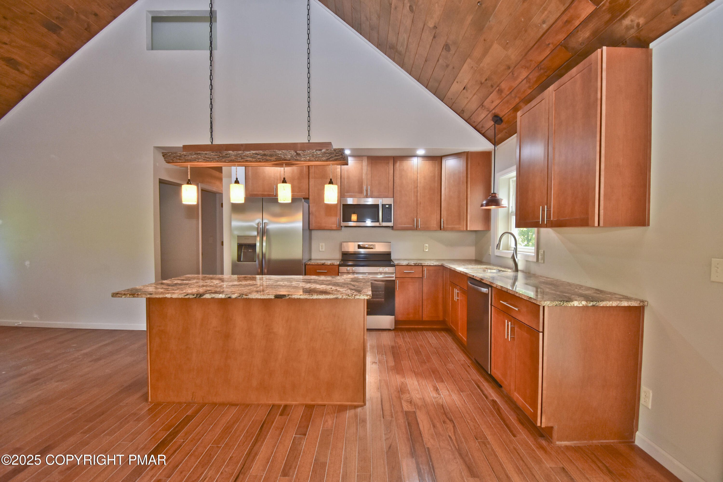 348 Summit Road Swiftwater, PA 18370 - Photo 9 of 47 a large kitchen with stainless steel appliances wooden floors and wooden cabinets