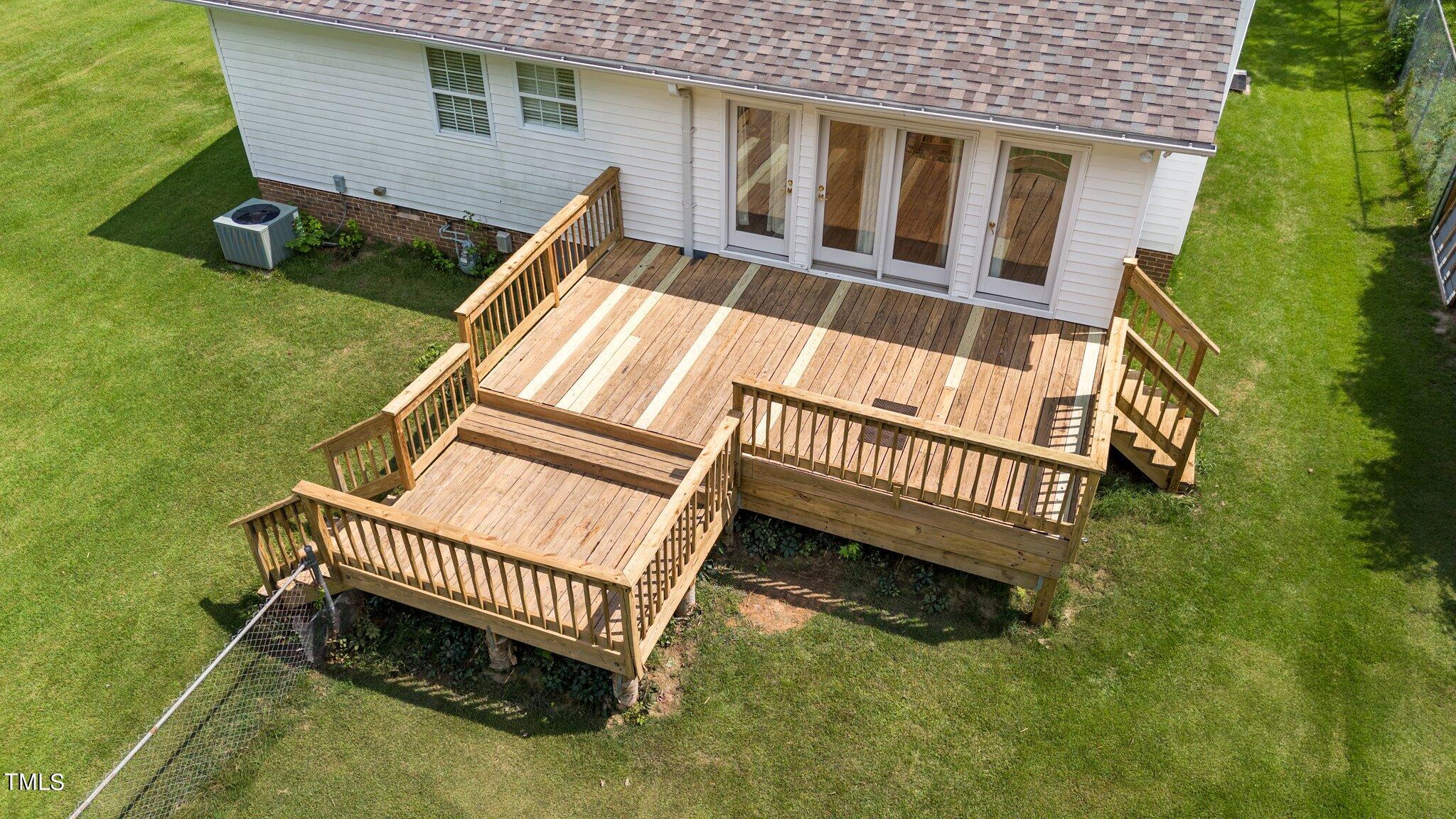 3965 Haithcock Road Raleigh, NC 27604 - Photo 26 of 30 a view of a house with a yard and deck