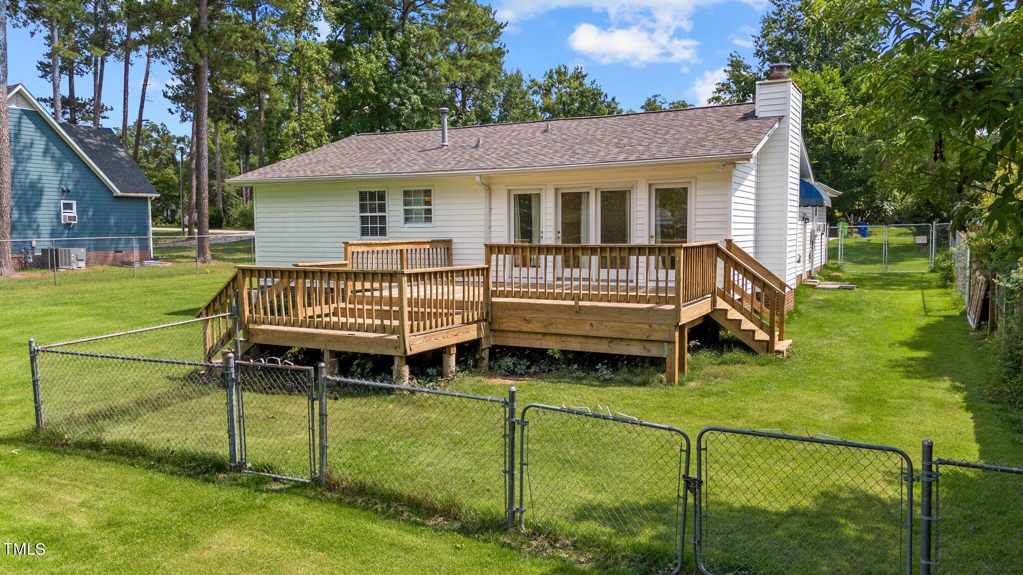 3965 Haithcock Road Raleigh, NC 27604 - Photo 27 of 30 a backyard of a house with garden and deck