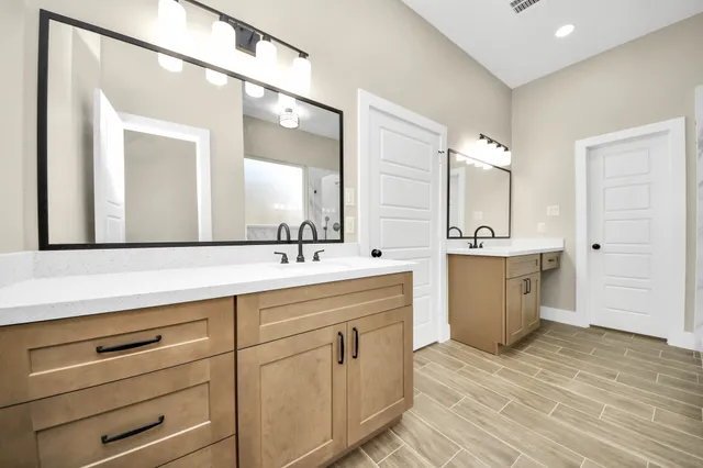 a spacious bathroom with a double vanity sink mirror and
