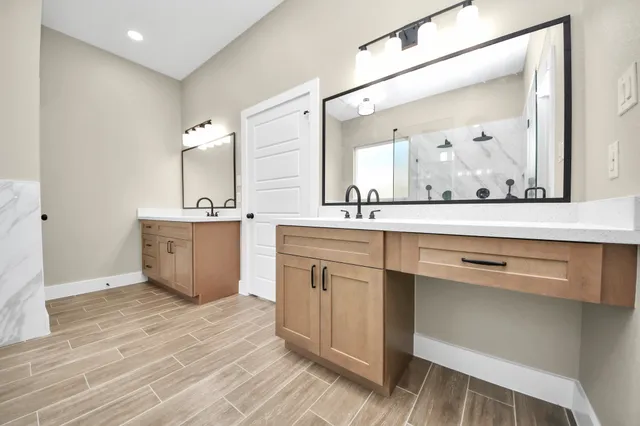 a bathroom with a sink vanity and mirror