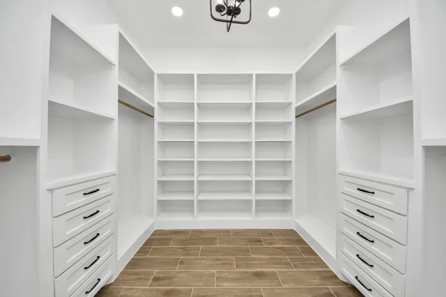 a view of walk in closet with empty racks