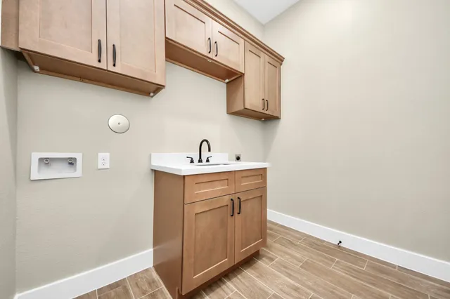 a kitchen with cabinets appliances and a wooden floor