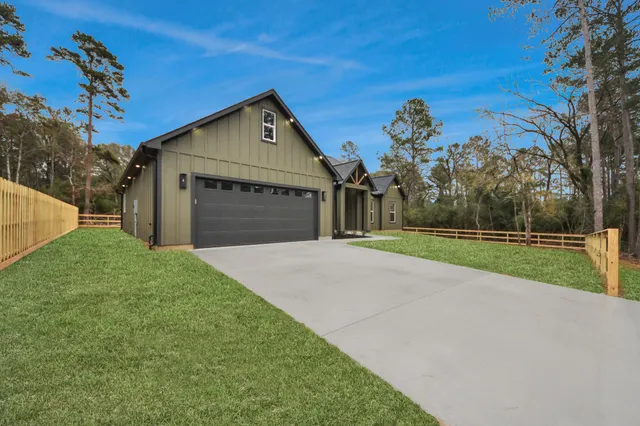 a front view of a house with yard and green space