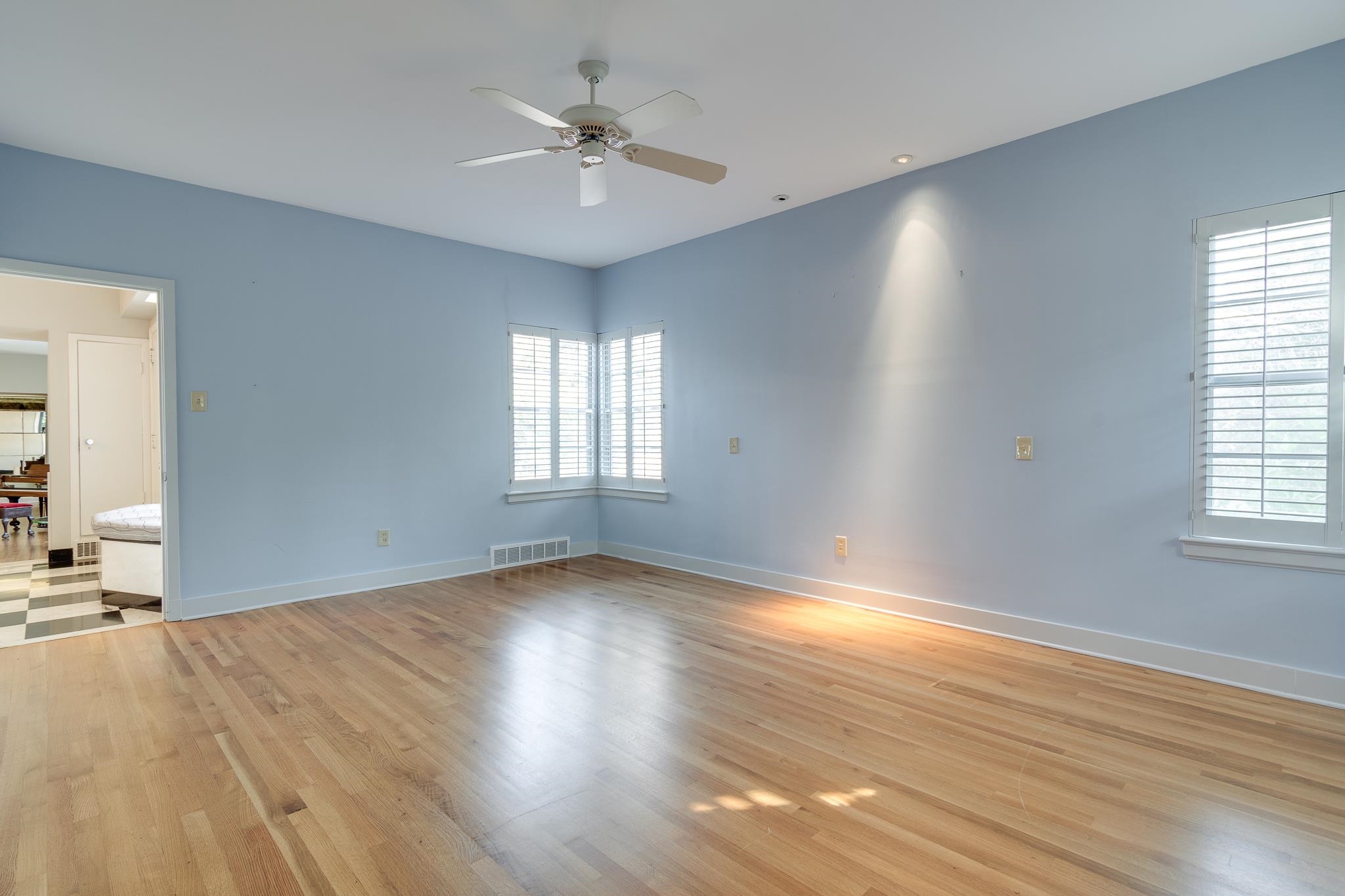 2929 Central Avenue Memphis, TN 38111 - Photo 13 of 25 an empty room with wooden floor and windows