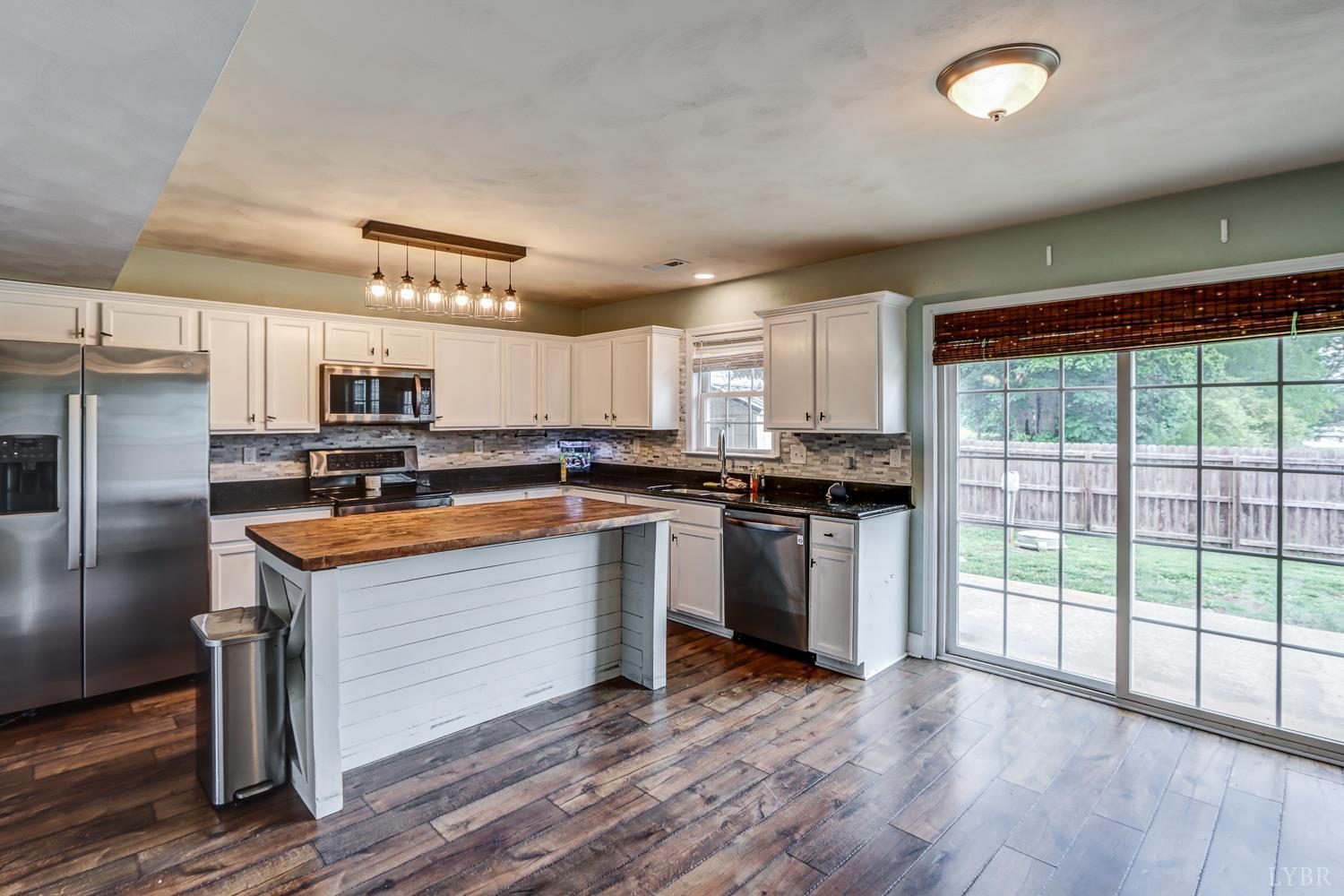 1057 Old Trail Road Forest, VA 24551 - Photo 12 of 49 a kitchen that has a lot of cabinets a sink and appliances in it