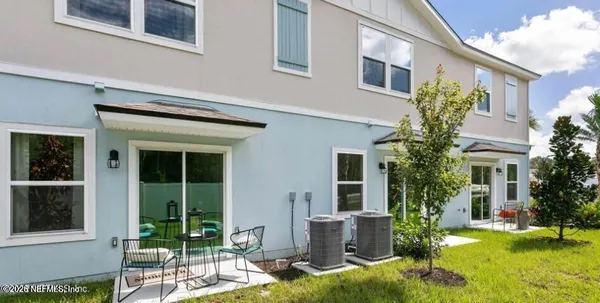 a view of a house with backyard porch and sitting area