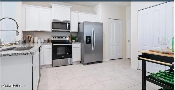 a kitchen with stainless steel appliances a refrigerator sink and stove