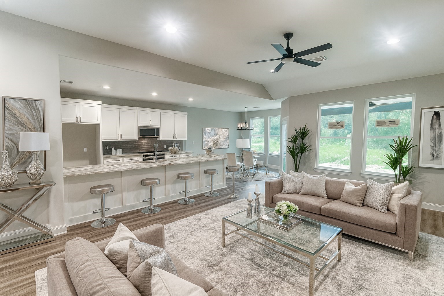 a living room with stainless steel appliances furniture and a view of kitchen