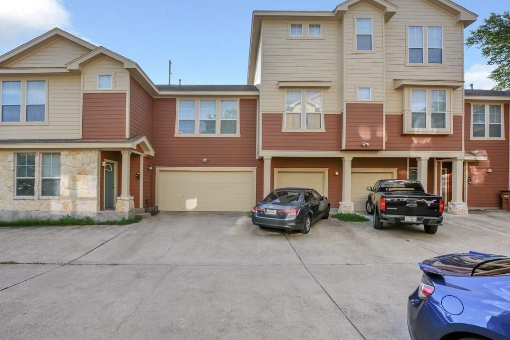 a car parked in front of a brick house