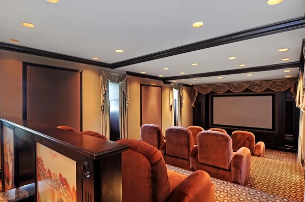 a media room with lots of chairs and a projector screen