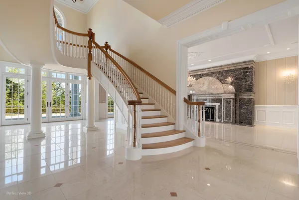 a view of staircase with lots of windows and white walls