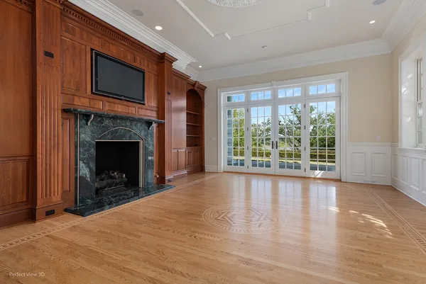 a view of an empty room with a fireplace and a window