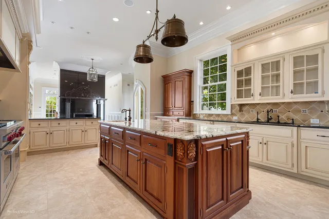 a kitchen with stainless steel appliances kitchen island granite countertop a stove and a sink