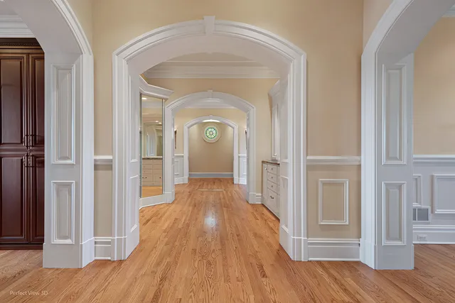 a view of a hallway with wooden floor and closet