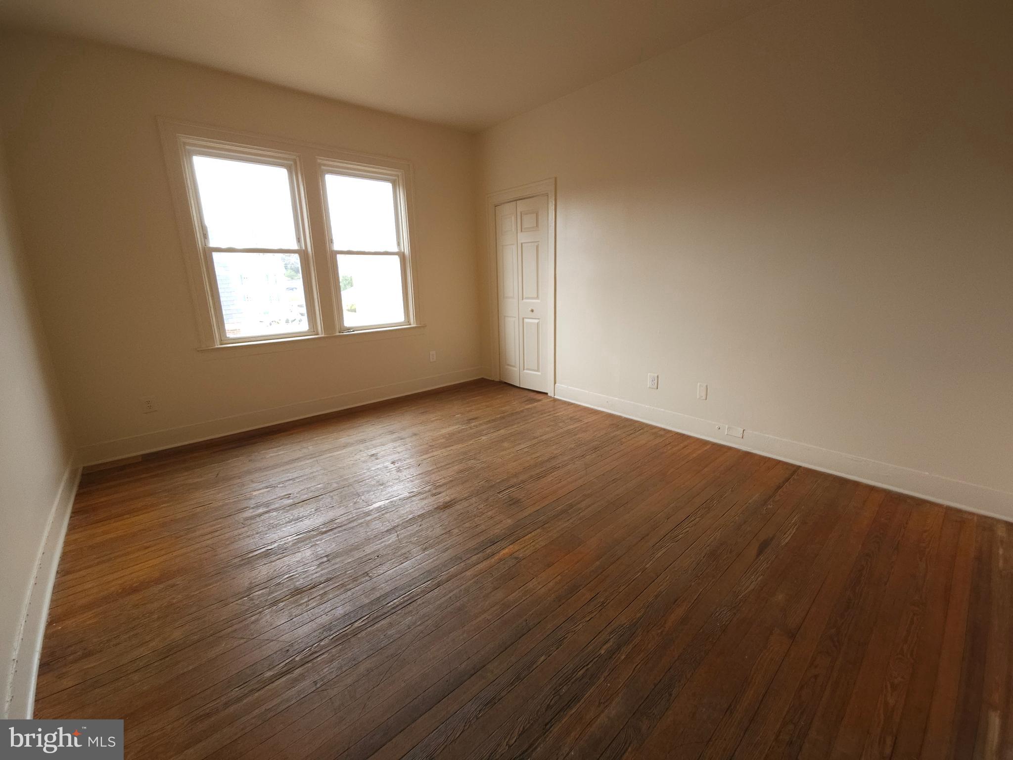 502 South Main Street, Unit 4 Culpeper, VA 22701 - Photo 5 of 11 an empty room with wooden floor and windows