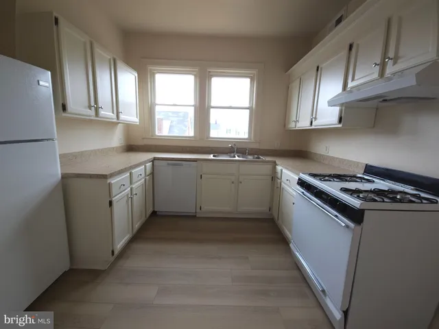 a kitchen with stainless steel appliances granite countertop a stove a sink dishwasher and a refrigerator