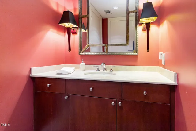 a bathroom with a sink vanity and a mirror