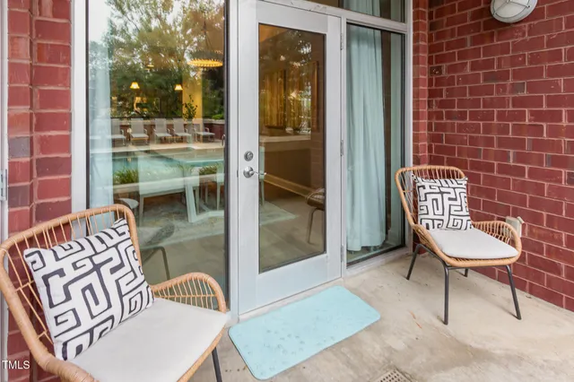 a view of a chairs and a table in the balcony