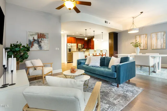 a living room with furniture and a chandelier