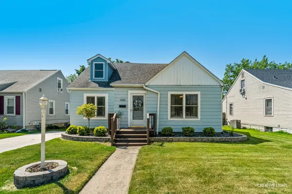 a front view of house with yard and green space