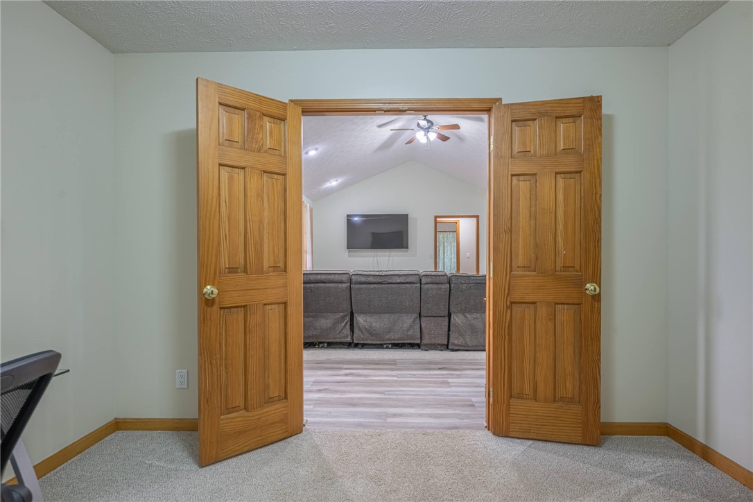 2645 Vance Road St. Paris, OH 43072 - Photo 16 of 35 Step into this media room featuring vaulted ceilings and stylish wood-paneled doors.