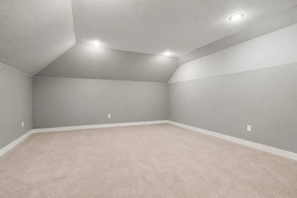 3908 Ranchman Boulevard Denton, TX 76210 - Photo 23 of 29 Recessed lighting illuminates an expansive room featuring carpeting and neutral wall tones