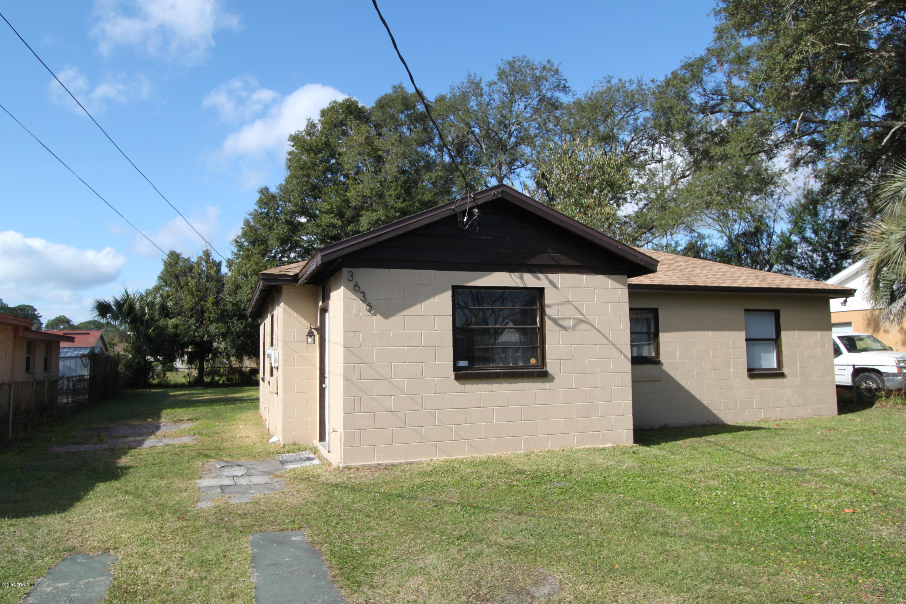 3636 Basil Road Jacksonville, FL 32207 - Photo 2 of 23 a front view of a house with a yard and garage