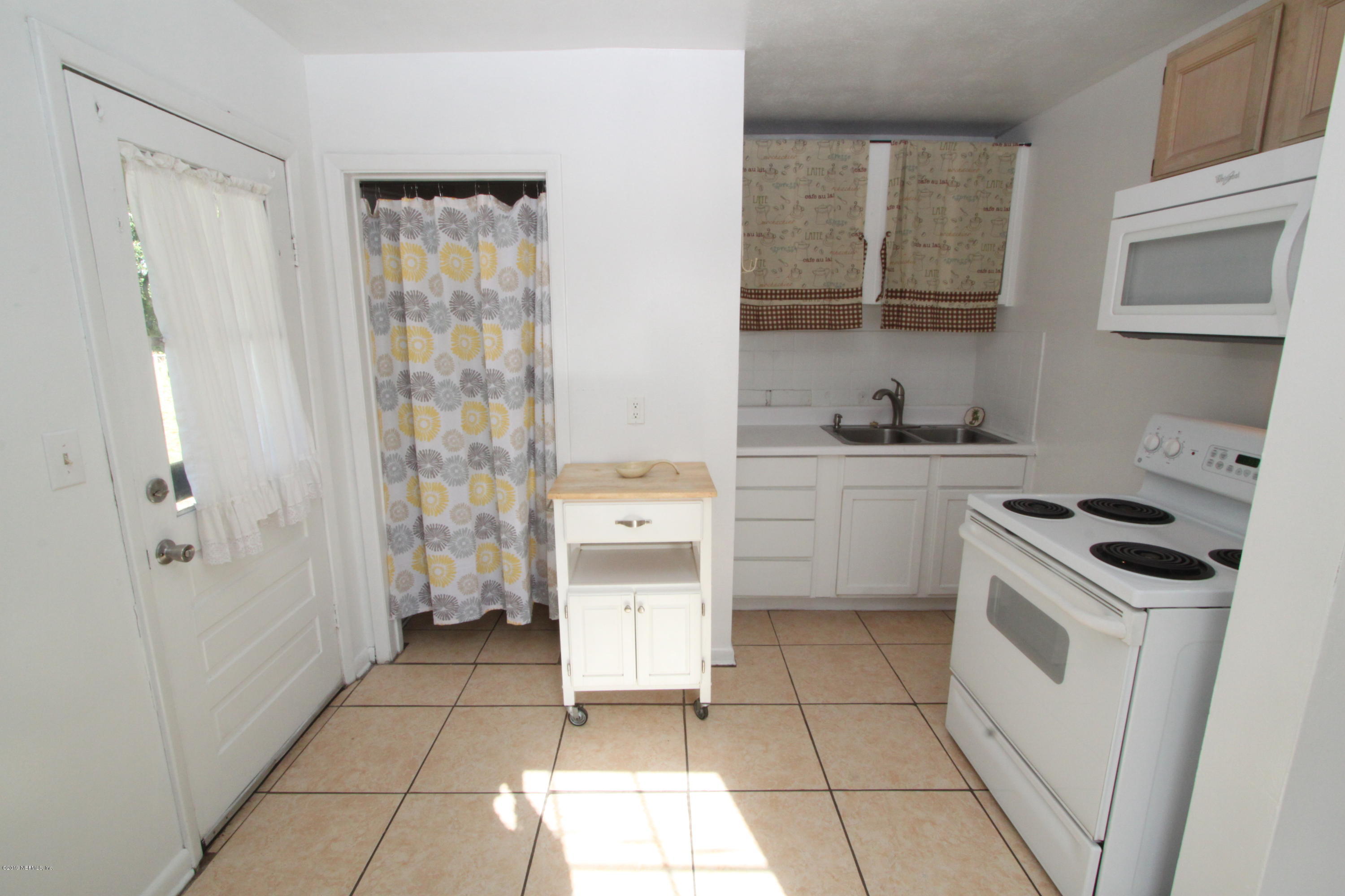 3636 Basil Road Jacksonville, FL 32207 - Photo 8 of 23 a kitchen with a stove a sink and a refrigerator