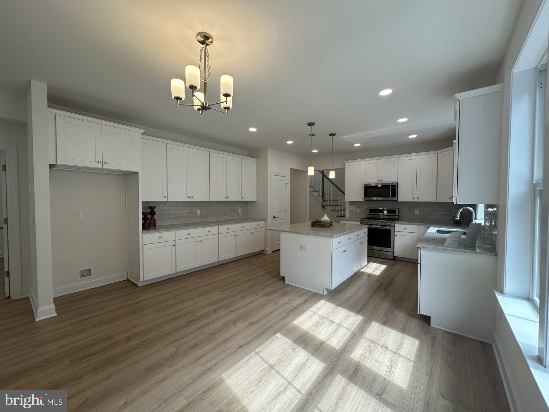 61 Kay Chiarello Way Hamilton, NJ 08690 - Photo 3 of 21 a large kitchen with cabinets a sink and dishwasher a refrigerator with wooden floor