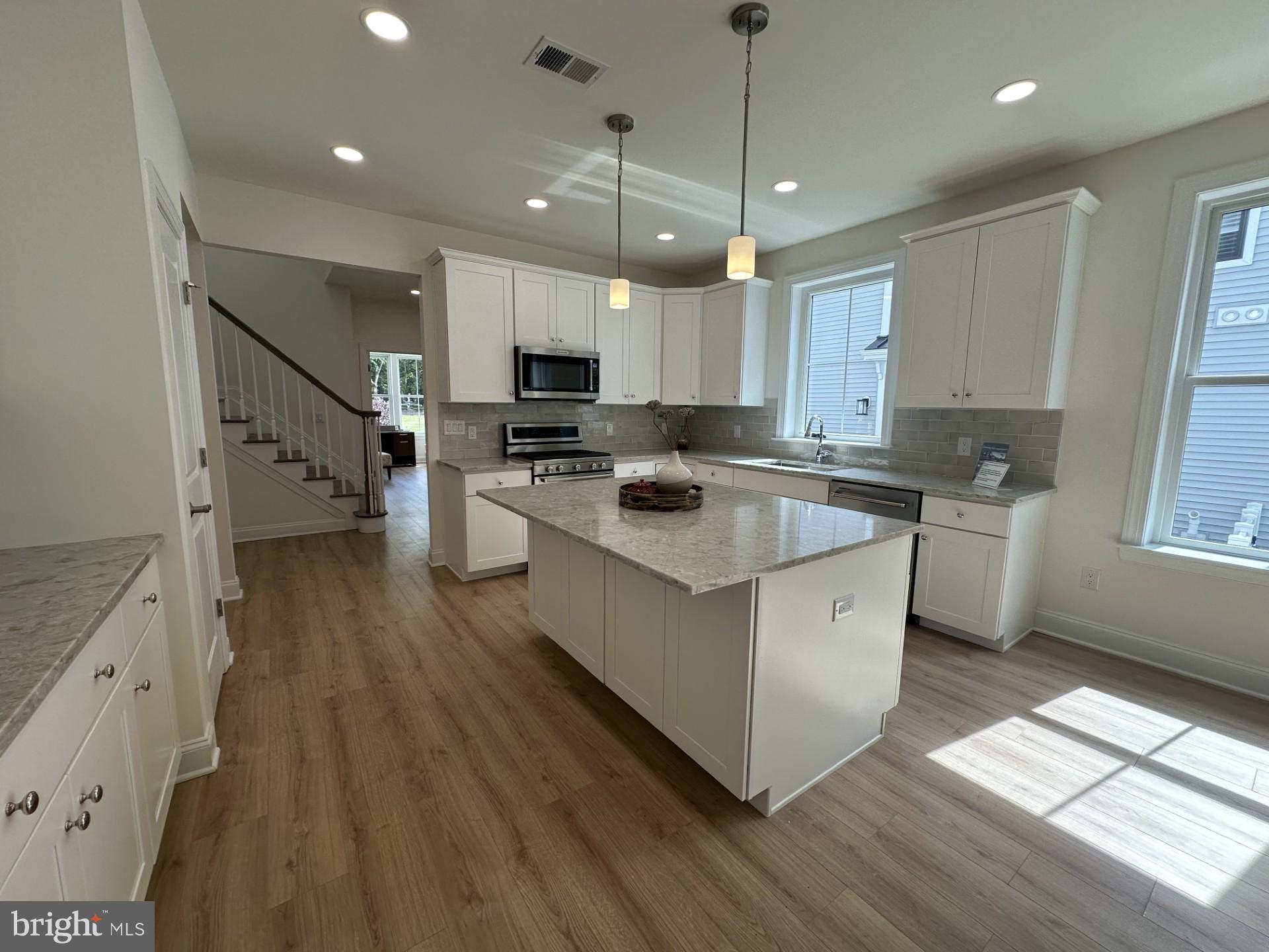 61 Kay Chiarello Way Hamilton, NJ 08690 - Photo 4 of 21 a kitchen with stove a sink and a refrigerator