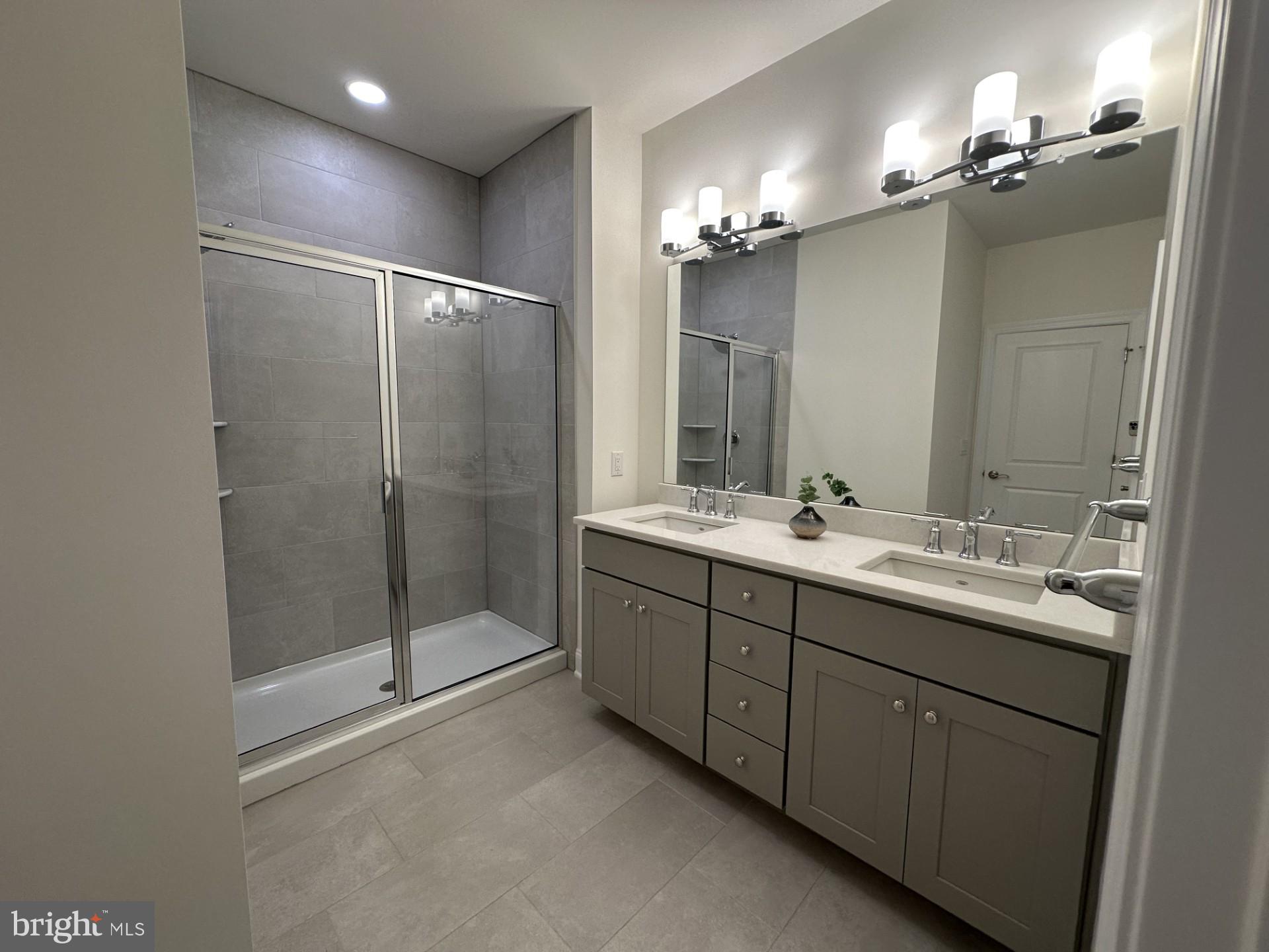 61 Kay Chiarello Way Hamilton, NJ 08690 - Photo 6 of 21 a bathroom with a double vanity sink mirror and shower