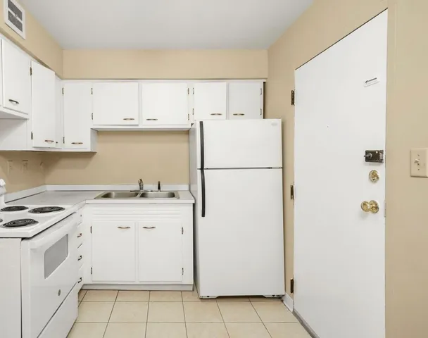 a view of a room with wooden floor and white walls