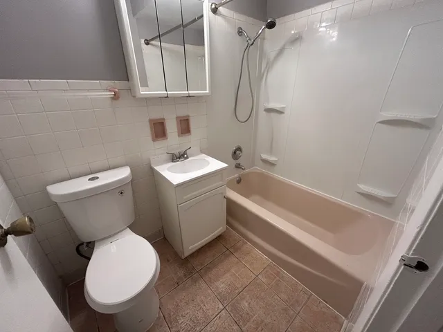 a bathroom with a toilet sink and shower