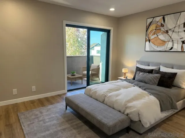 a view of a small space with wooden floor and a window